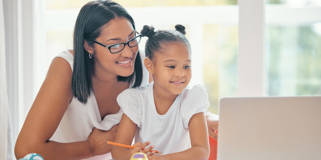 A mom and daughter using a computer